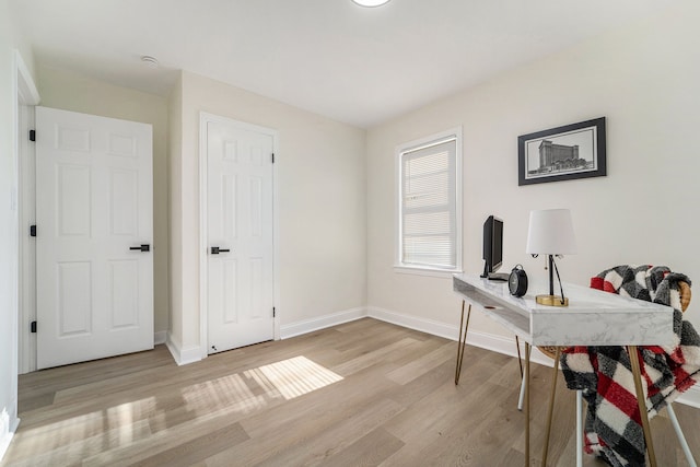office area with light wood finished floors and baseboards