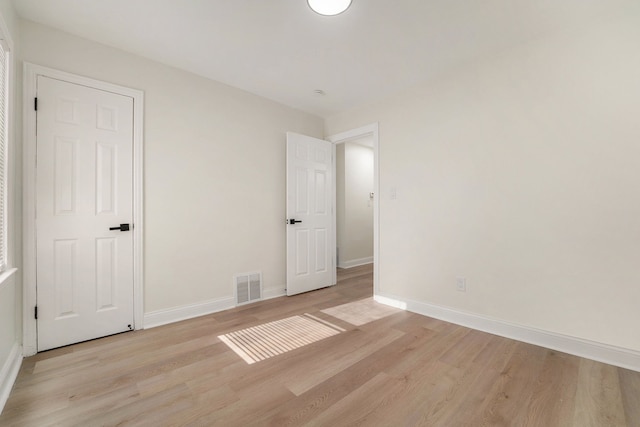 unfurnished bedroom with light wood-type flooring and baseboards