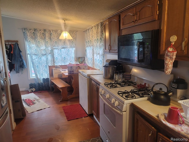3092 Durant Hts, Grand Blanc, MI 48507 - kitchen featuring black microwave, white gas range, light countertops, wood finished floors, and a textured ceiling
