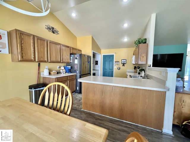 9304 Orchard Ct, Davison, MI 48423 - kitchen featuring vaulted ceiling, a sink, dark wood-style flooring, light countertops, and a peninsula