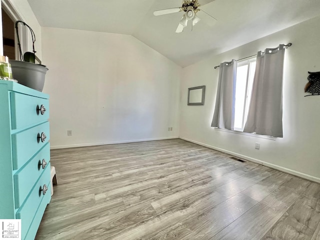 9304 Orchard Ct, Davison, MI 48423 - unfurnished bedroom with vaulted ceiling, light wood-style flooring, baseboards, and a ceiling fan