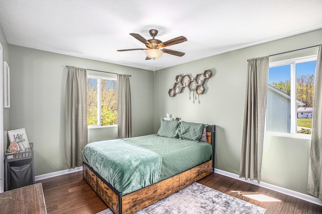 bedroom featuring wood finished floors, baseboards, and ceiling fan