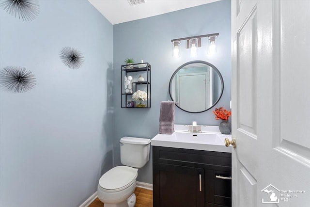 25345 Hunter Ln, Flat Rock, MI 48134 - bathroom with vanity, toilet, baseboards, and wood finished floors