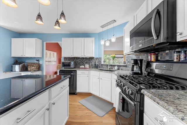 25345 Hunter Ln, Flat Rock, MI 48134 - kitchen with gas stove, a sink, dishwasher, light wood-style floors, and tasteful backsplash