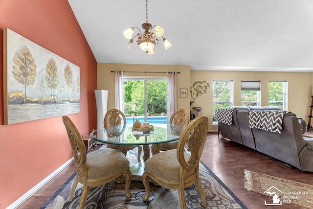 25345 Hunter Ln, Flat Rock, MI 48134 - dining area featuring a chandelier, plenty of natural light, wood finished floors, vaulted ceiling, and baseboards