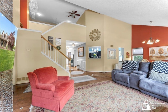 25345 Hunter Ln, Flat Rock, MI 48134 - living area with wood finished floors, high vaulted ceiling, stairway, a chandelier, and a ceiling fan