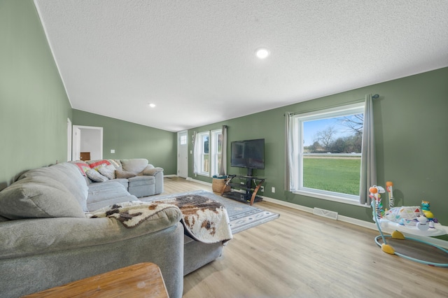 3311 5 Mile Rd, Sears, MI 49679 - living room featuring a textured ceiling, light wood-style flooring, and baseboards