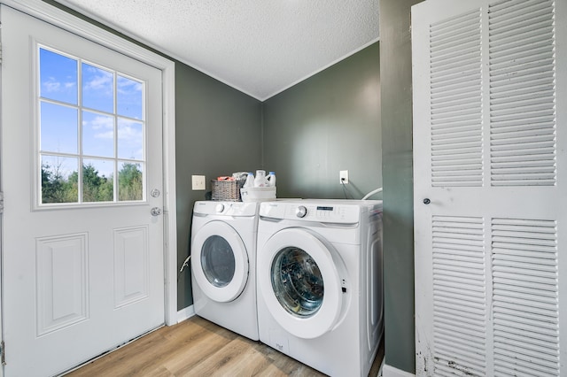 3311 5 Mile Rd, Sears, MI 49679 - laundry area with separate washer and dryer, a textured ceiling, and light wood-style flooring