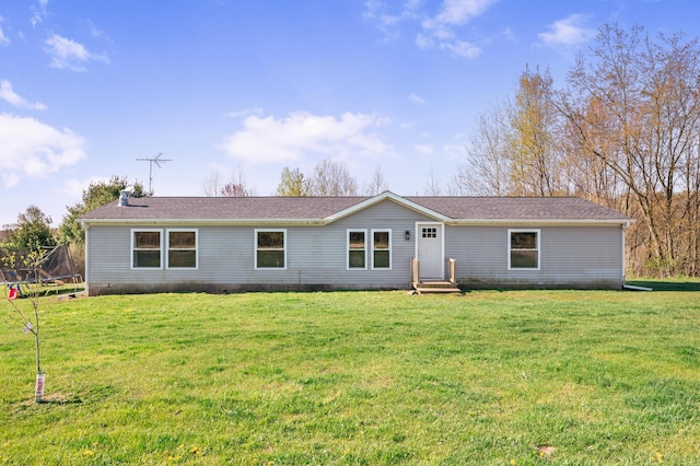 3311 5 Mile Rd, Sears, MI 49679 - ranch-style home with a trampoline, a front lawn, and roof with shingles