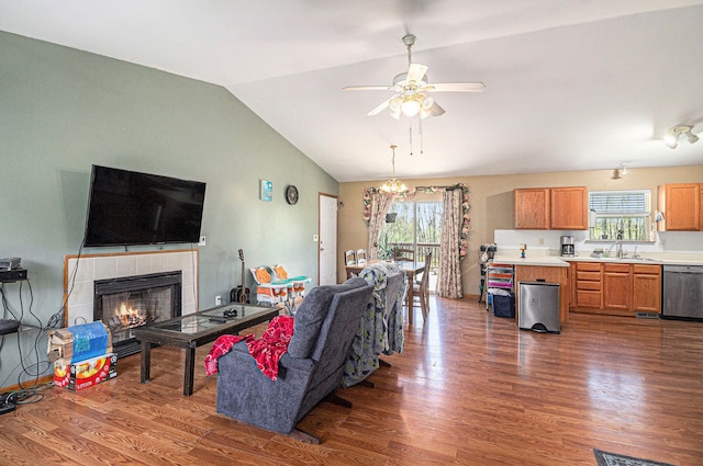 6606 Preston Rd, Howell, MI 48855 - living room featuring ceiling fan, dark wood-style floors, vaulted ceiling, and a tile fireplace