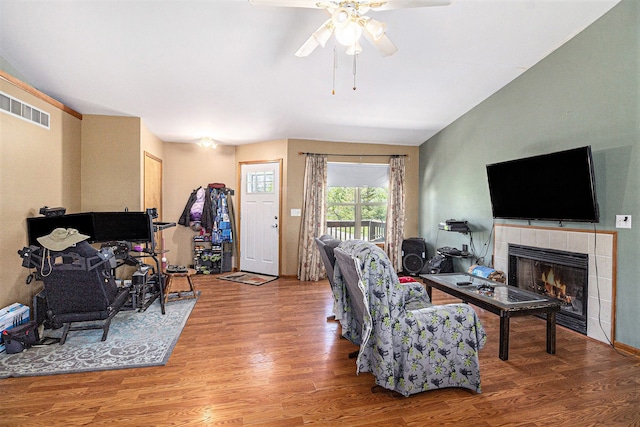 6606 Preston Rd, Howell, MI 48855 - living area featuring ceiling fan, a tile fireplace, and wood finished floors