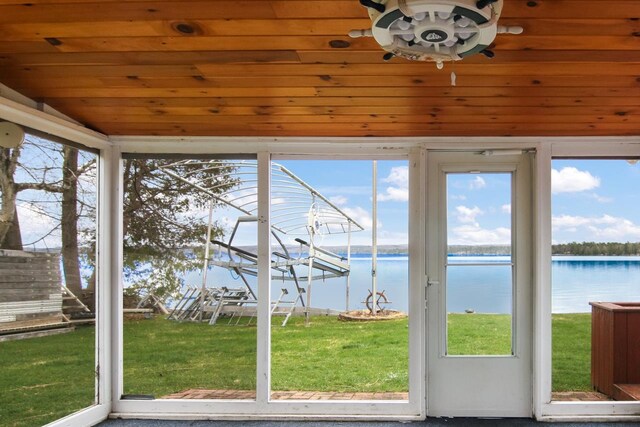 12225 SW Torch Lake Dr SW, Rapid City, MI 49676 - unfurnished sunroom with a water view, healthy amount of natural light, and vaulted ceiling