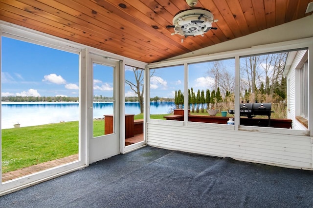 12225 SW Torch Lake Dr SW, Rapid City, MI 49676 - sunroom with vaulted ceiling, a water view, and a ceiling fan