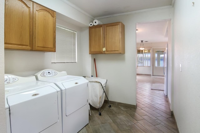 12225 SW Torch Lake Dr SW, Rapid City, MI 49676 - clothes washing area with washer and clothes dryer, cabinet space, ornamental molding, and baseboards