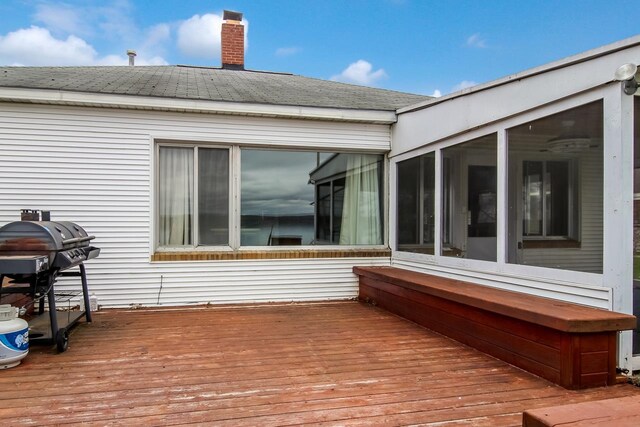 12225 SW Torch Lake Dr SW, Rapid City, MI 49676 - wooden deck featuring a grill and a sunroom