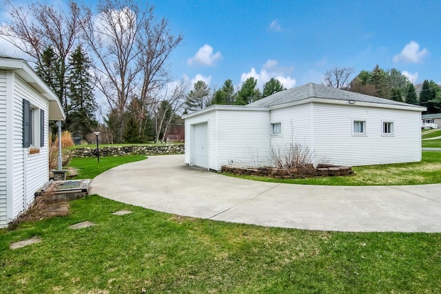 12225 SW Torch Lake Dr SW, Rapid City, MI 49676 - view of home's exterior with a yard and a garage