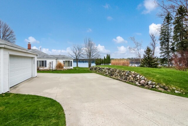12225 SW Torch Lake Dr SW, Rapid City, MI 49676 - view of patio featuring concrete driveway