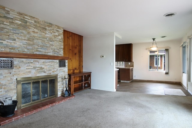 12225 SW Torch Lake Dr SW, Rapid City, MI 49676 - unfurnished living room featuring carpet floors, baseboards, and a fireplace