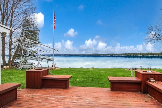 12225 SW Torch Lake Dr SW, Rapid City, MI 49676 - deck featuring a water view and a lawn