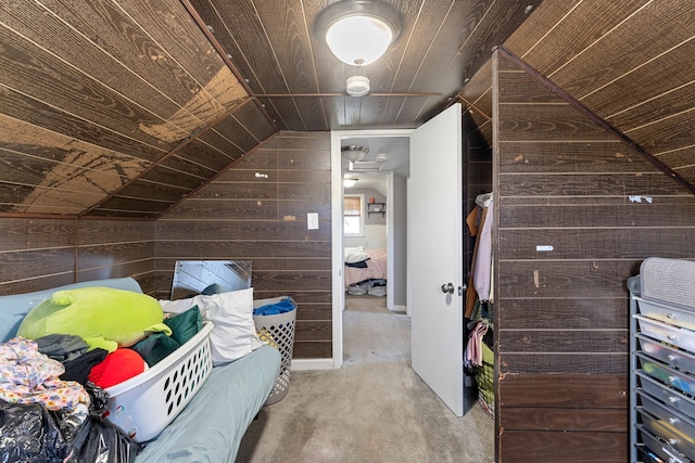 carpeted bedroom with wooden walls, wooden ceiling, and lofted ceiling