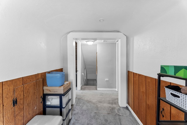 hallway with light colored carpet