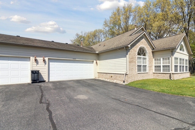 36160 Abbey Dr, Westland, MI 48185 - view of home's exterior featuring brick siding, asphalt driveway, a shingled roof, an attached garage, and a lawn