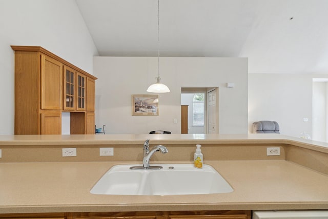 36160 Abbey Dr, Westland, MI 48185 - kitchen featuring a sink, glass insert cabinets, light countertops, brown cabinets, and pendant lighting