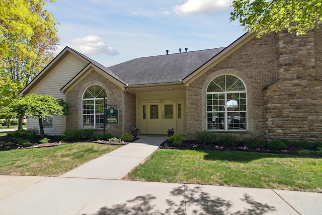 36160 Abbey Dr, Westland, MI 48185 - view of front facade with a front lawn, brick siding, and a shingled roof