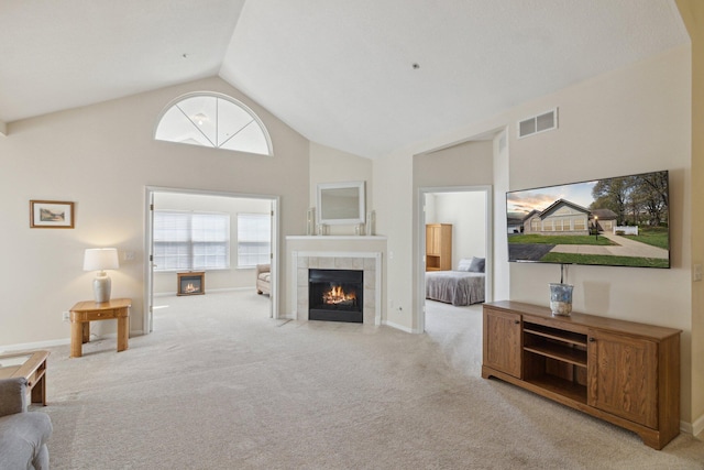 36160 Abbey Dr, Westland, MI 48185 - carpeted living room with a tiled fireplace, high vaulted ceiling, and baseboards