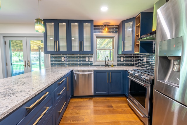 3484 Lakeshore Dr, Monroe, MI 48162 - kitchen with appliances with stainless steel finishes, a sink, blue cabinets, healthy amount of natural light, and recessed lighting