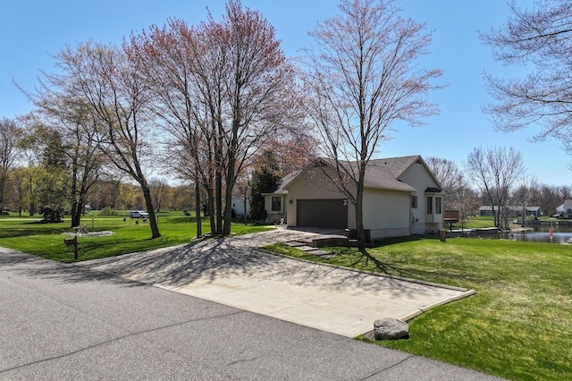 8439 Shoshoni Pass, Pigeon, MI 48755 - view of side of home featuring driveway, a garage, a yard, and a water view