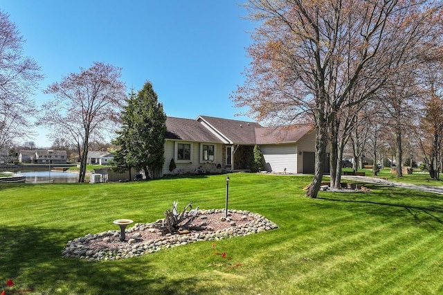 8439 Shoshoni Pass, Pigeon, MI 48755 - rear view of property with a garage, a yard, and a water view