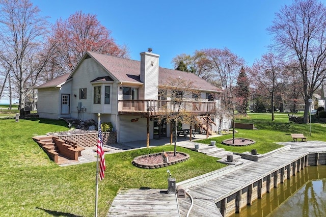 8439 Shoshoni Pass, Pigeon, MI 48755 - back of house featuring a patio, a wooden deck, a chimney, and a lawn