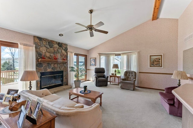 8439 Shoshoni Pass, Pigeon, MI 48755 - carpeted living room with ceiling fan, a stone fireplace, high vaulted ceiling, beamed ceiling, and a wainscoted wall