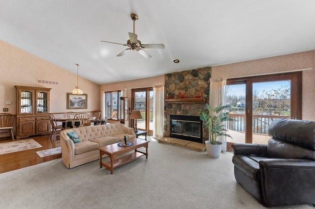 8439 Shoshoni Pass, Pigeon, MI 48755 - living area featuring ceiling fan, healthy amount of natural light, lofted ceiling, and a fireplace