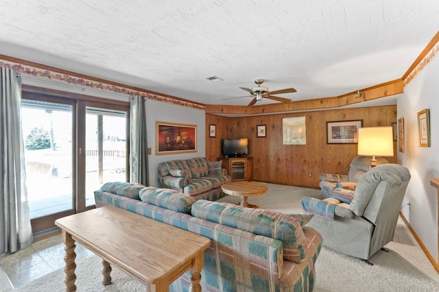 8439 Shoshoni Pass, Pigeon, MI 48755 - living room with wooden walls, a ceiling fan, a textured ceiling, and baseboards