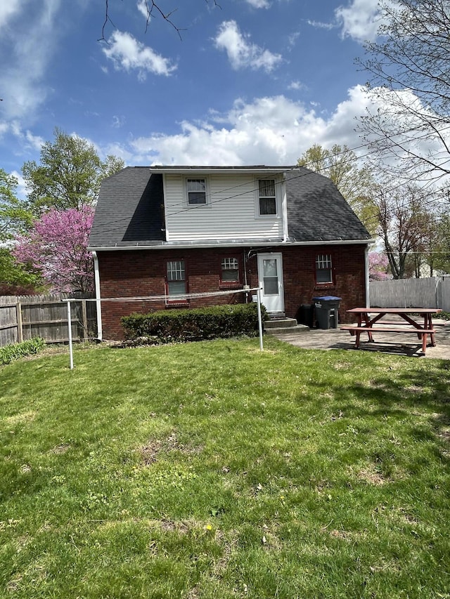 rear view of property featuring entry steps and brick siding
