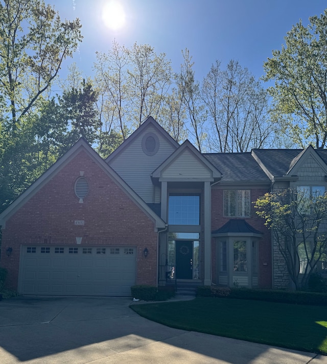 43632 Abbey Cir, Canton, MI 48187 - view of front of house with brick siding, an attached garage, and concrete driveway