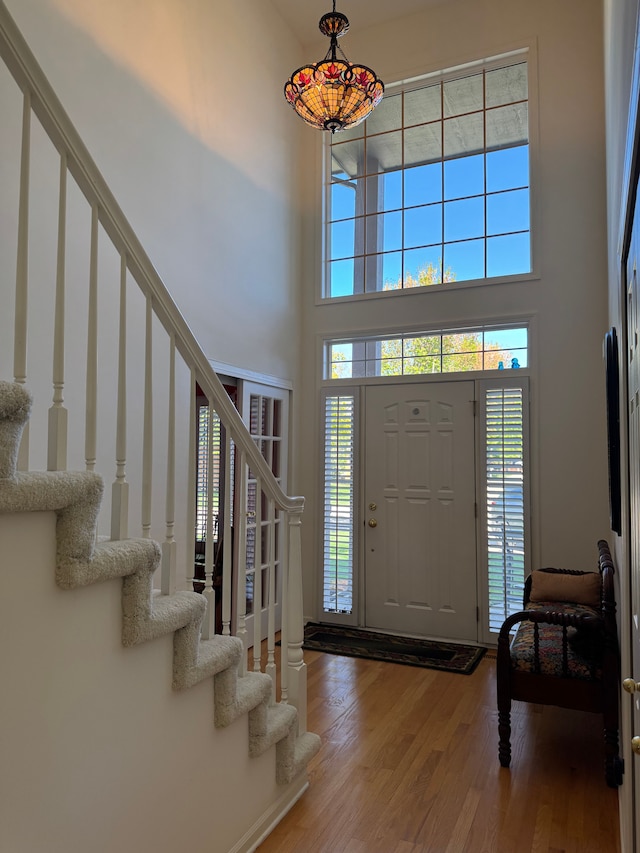 43632 Abbey Cir, Canton, MI 48187 - foyer entrance with a high ceiling, stairs, and wood finished floors