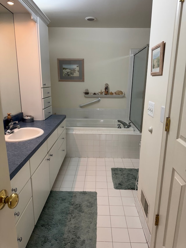 43632 Abbey Cir, Canton, MI 48187 - bathroom featuring tile patterned flooring, a relaxing tiled tub, and vanity