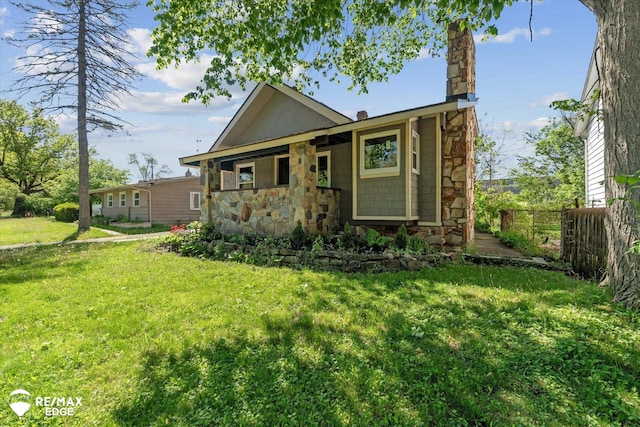 1418 Sunnyside Ave, Flint, MI 48503 - view of front facade featuring stone siding and a chimney