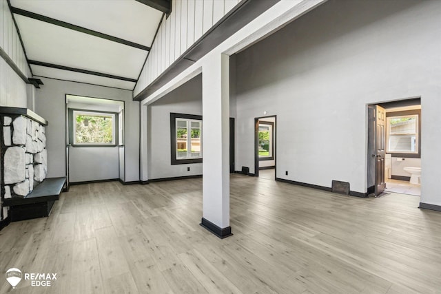 1418 Sunnyside Ave, Flint, MI 48503 - unfurnished living room featuring high vaulted ceiling, light wood finished floors, and baseboards