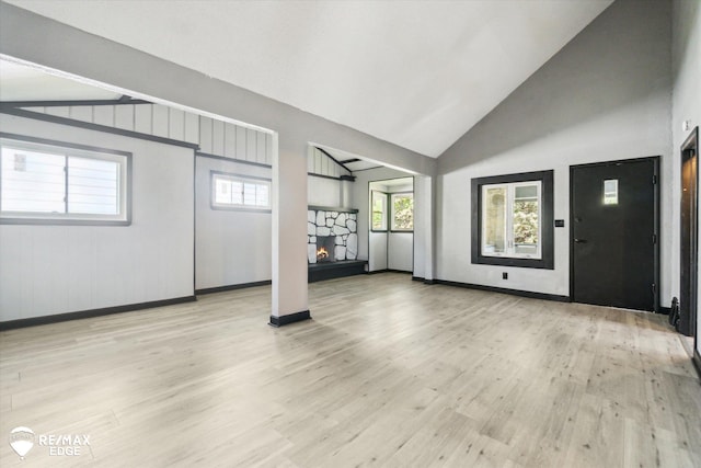 1418 Sunnyside Ave, Flint, MI 48503 - entrance foyer with wood finished floors, a fireplace, baseboards, and high vaulted ceiling