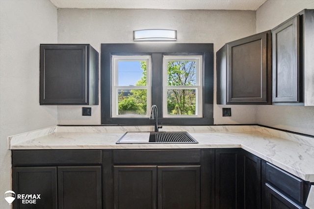 1418 Sunnyside Ave, Flint, MI 48503 - kitchen with a sink and light stone countertops