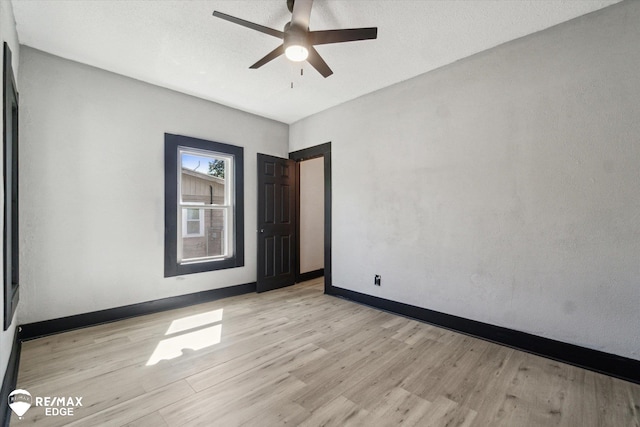 1418 Sunnyside Ave, Flint, MI 48503 - empty room with light wood-style flooring, ceiling fan, and baseboards