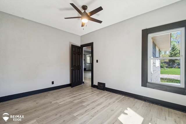 1418 Sunnyside Ave, Flint, MI 48503 - unfurnished room featuring light wood-style flooring, baseboards, and ceiling fan