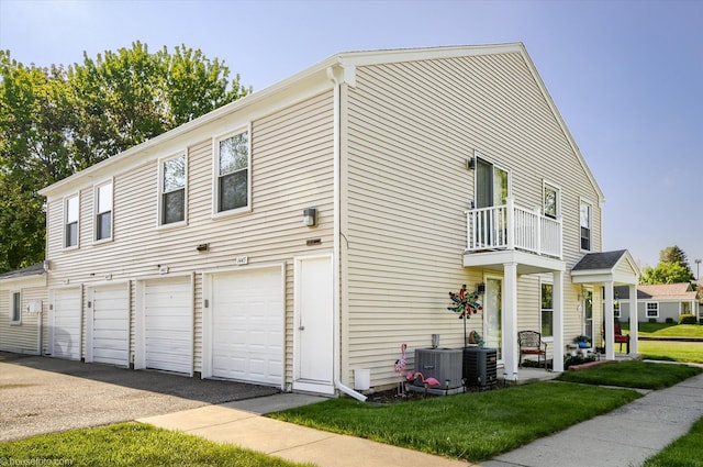 1445 Steeple Chase, Davison, MI 48423 - view of home's exterior with a balcony, cooling unit, an attached garage, asphalt driveway, and a lawn