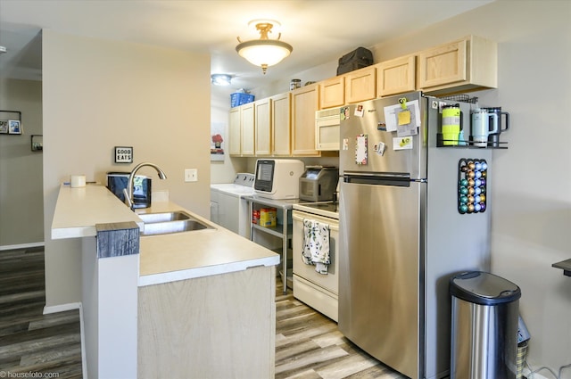 1445 Steeple Chase, Davison, MI 48423 - kitchen with light brown cabinets, a peninsula, white appliances, washer and dryer, and light wood finished floors