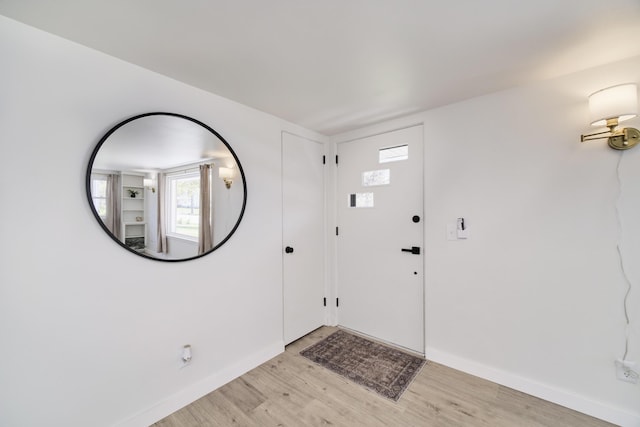 923 Maple St, Ludington, MI 49431 - foyer featuring light wood finished floors and baseboards