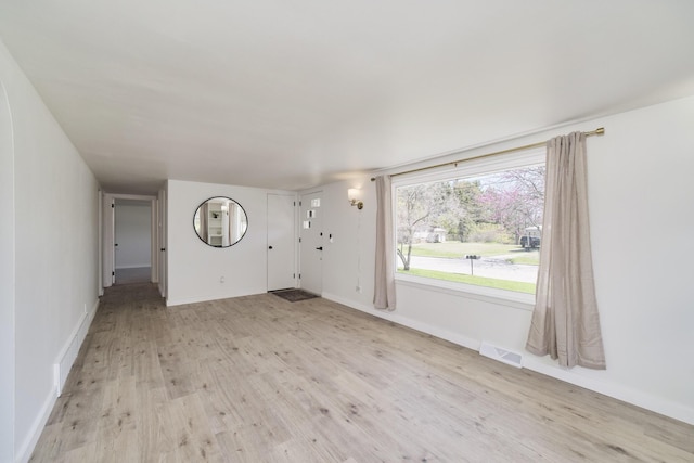 923 Maple St, Ludington, MI 49431 - unfurnished living room featuring light wood-style flooring and baseboards